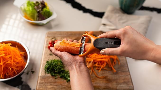 Zyliss Julienne Y Peeler – Ultra-Sharp Stainless Steel Blade for Carrots, Zucchini & Potatoes – Ergonomic Wheatstraw Grip – Built-in Eye Cutter & Safety Cover – Dishwasher Safe – Orange